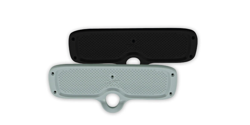 transom-pad-300x120mm Two skateboard deck guards in black and grey, featuring textured surfaces and mounting holes for protection and durability.