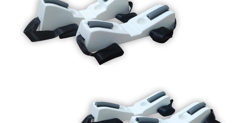 White plastic ski boot bindings with black and gray details on a white background.