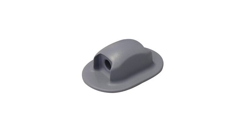 Gray plastic boat eyelet cleat on white background, used for securing ropes and cords securely.