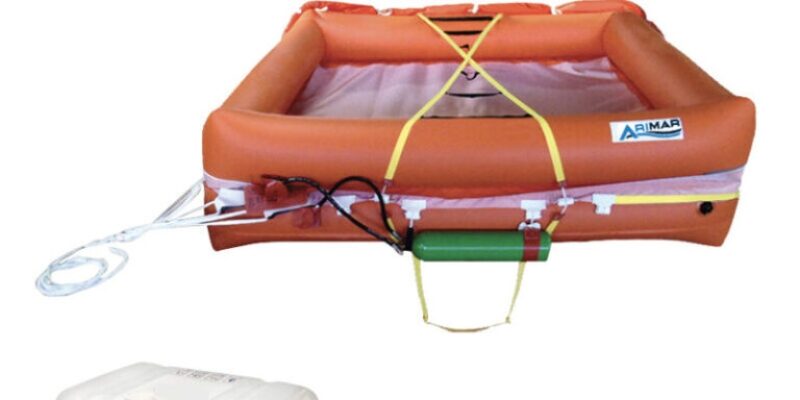 Orange inflatable life raft with storage container and Italian flag emblem, designed for marine safety.