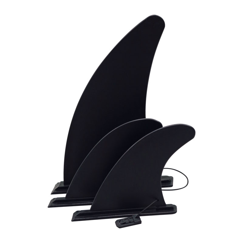 Three black surfboard fins of varying sizes arranged vertically on a white background.